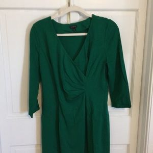 A emerald green dress with a wrap in front